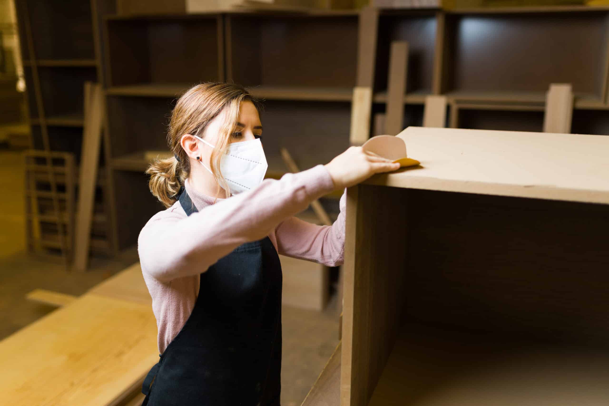 House painters Edmonton spraying a smooth white finish on kitchen cabinet doors in a King Edward Park Edmonton home.