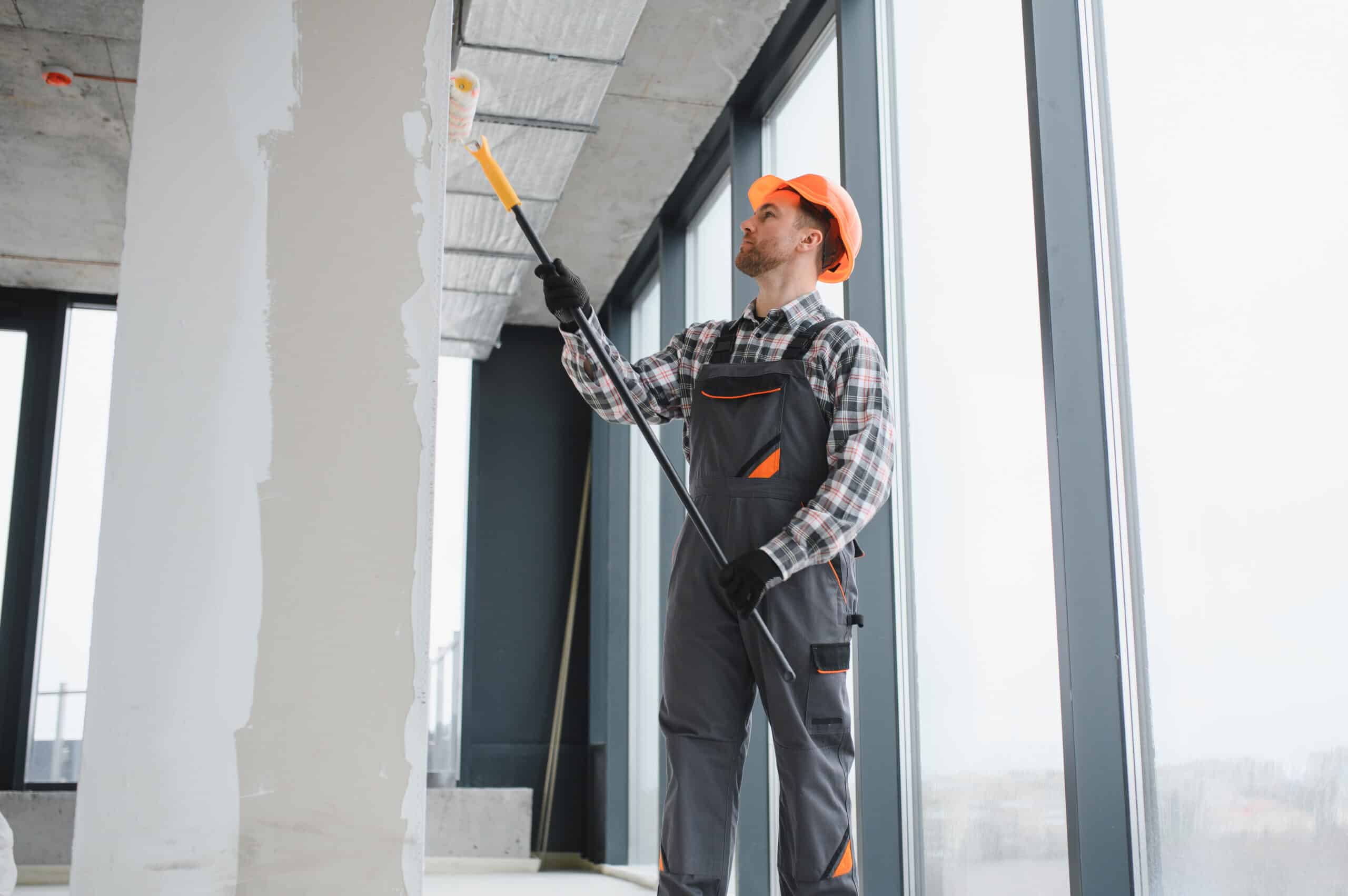 Commercial painters Edmonton rolling fresh paint on the interior walls of a Fulton Place Edmonton office space.
